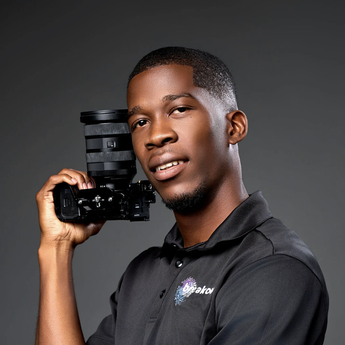 La'Quan Williams, founder of Breakout Creative Agency, holding a camera